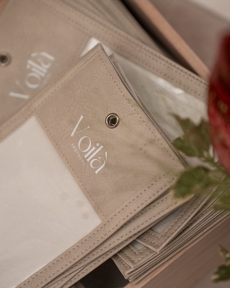The Voil&agrave;-stamped phone pouches, stacked with the clear window uppermost