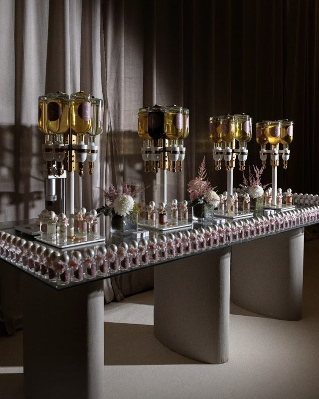 The perfume table, with the guests' bottles set out along it
