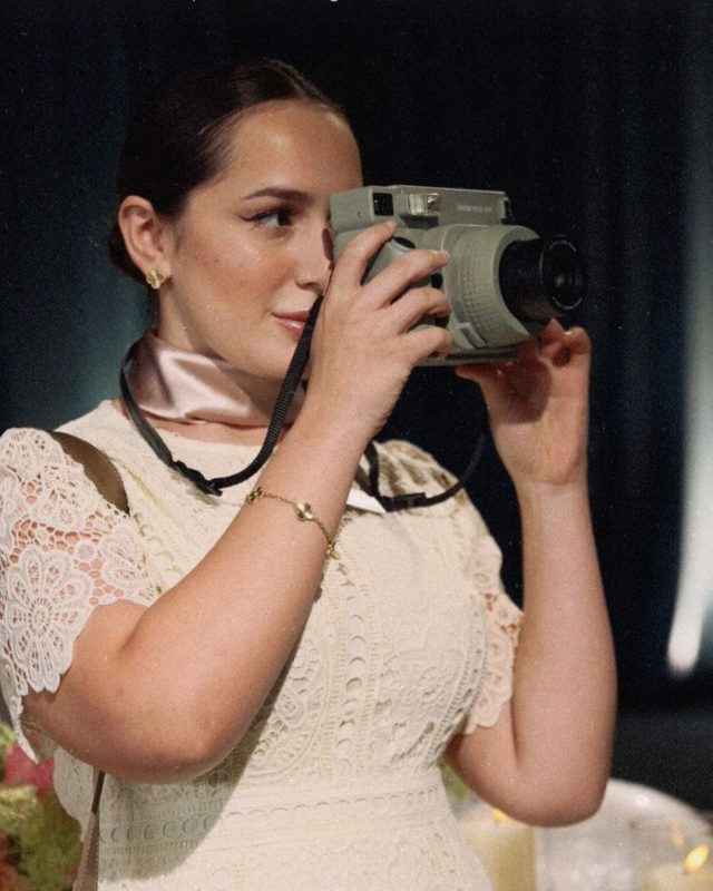 A guest taking an instant photograph with a Polaroid camera