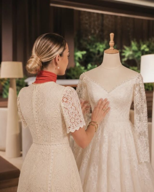 A Voil&agrave; Protocol assistant preparing the bride's dress on the mannequin in the suite
