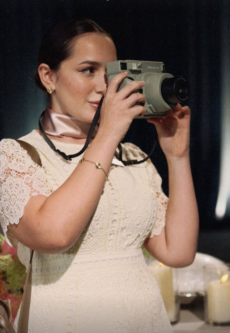 A guest taking a polaroid at the celebration